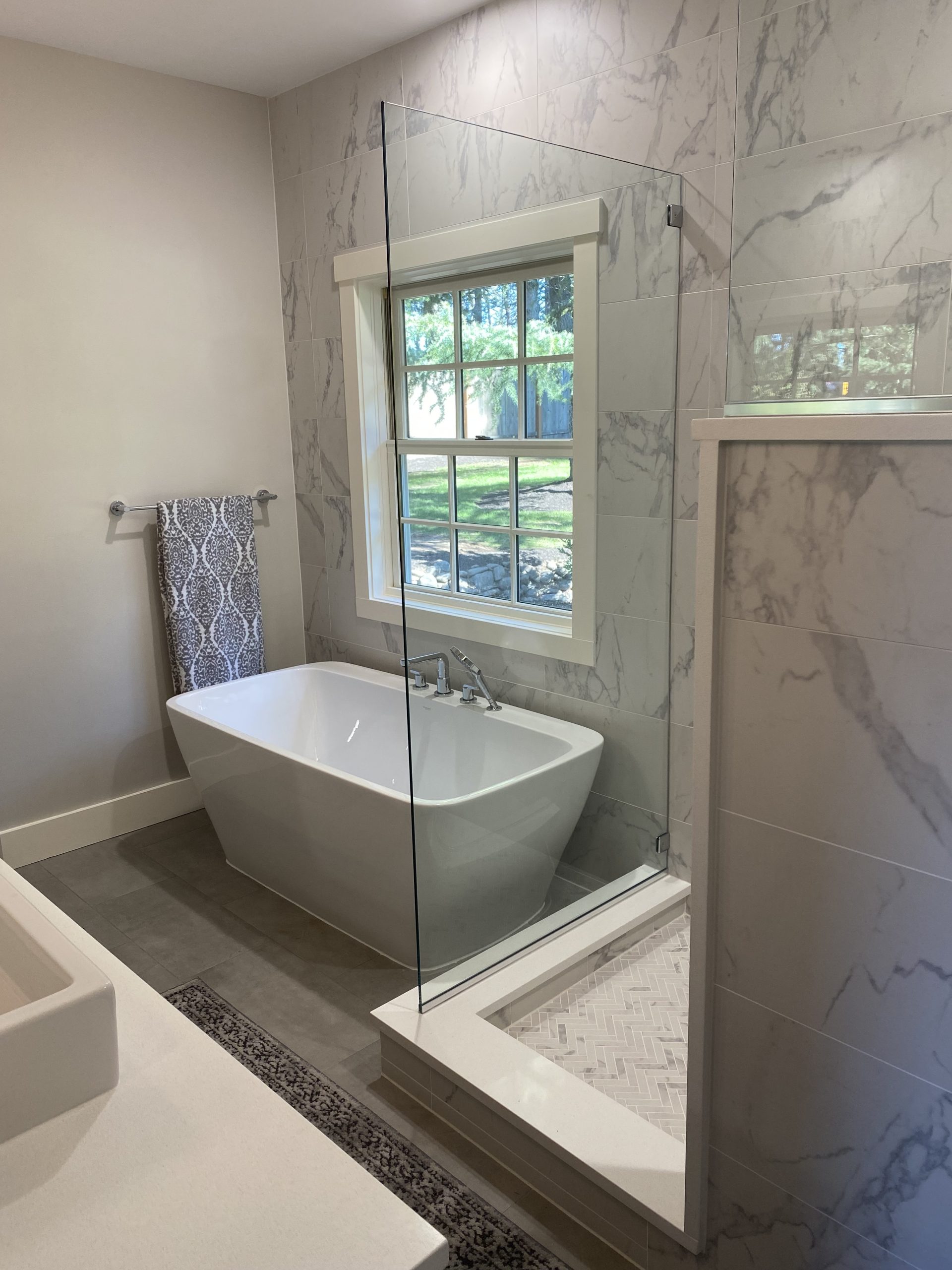 Luxury bathroom remodeling project completed by Jason Smith Construction featuring a freestanding soaking tub, custom tile shower, frameless glass enclosure, marble-look wall tile, and modern bathroom design in Clackamas County, Oregon. High-end bathroom renovation craftsmanship for homeowners in Canby, Wilsonville, Oregon City, West Linn, Molalla, and surrounding Northwest Oregon communities.