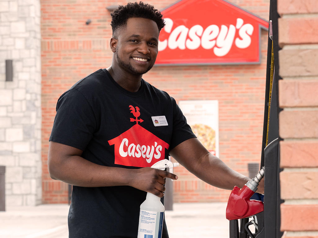 Casey's team member cleaning gas pumps Casey's Mendota (779)340-0306