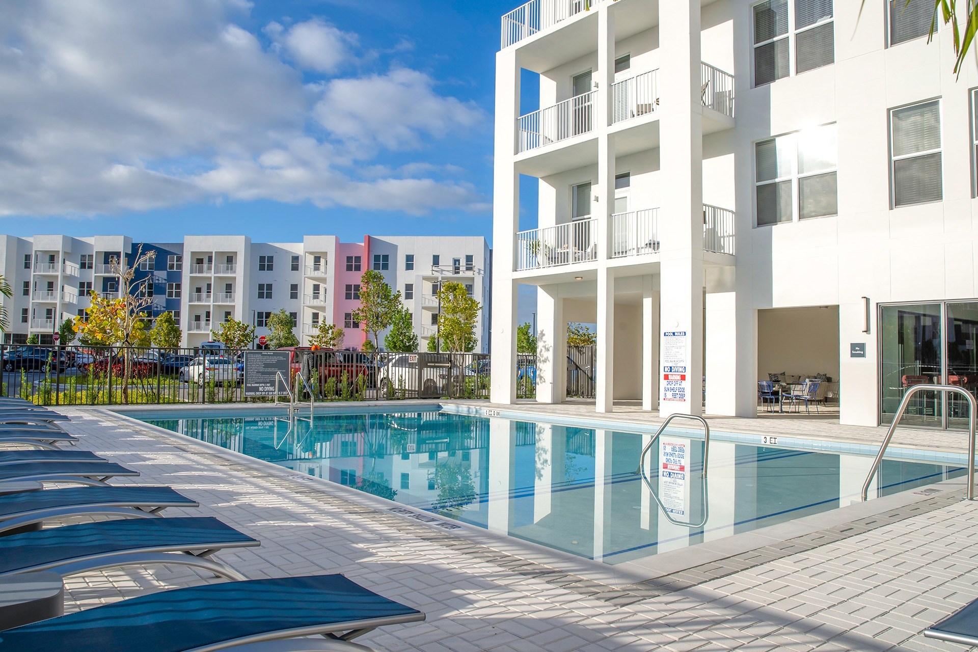 Resort style pool with sundeck and lounge chairs