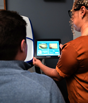 Doctor looking at screen with a patient