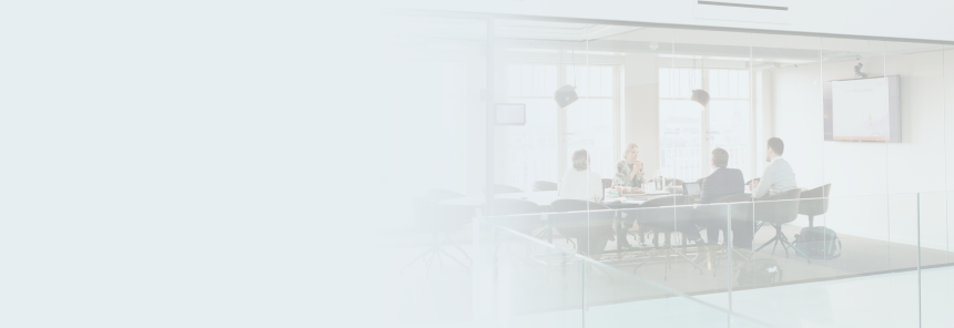 Four people meeting in a board room.