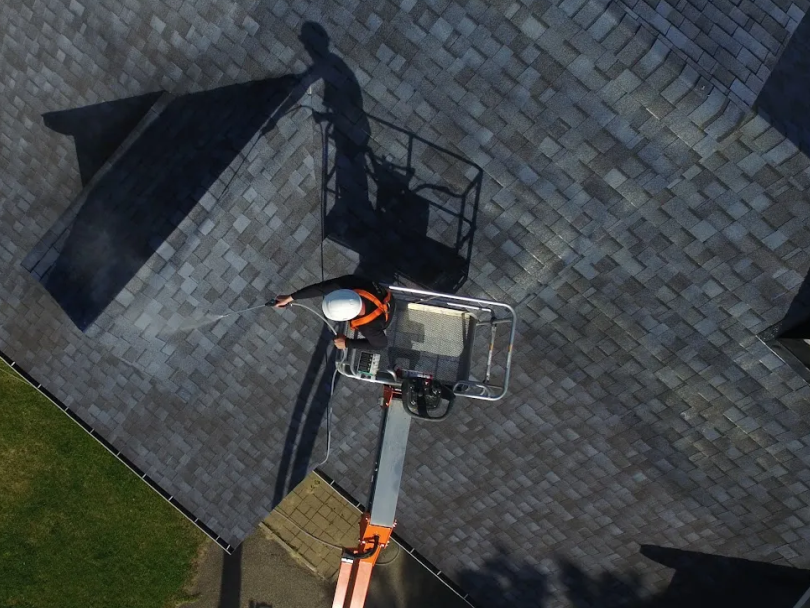 Headwaters Roofing Applying GoNano sealant from a lift.