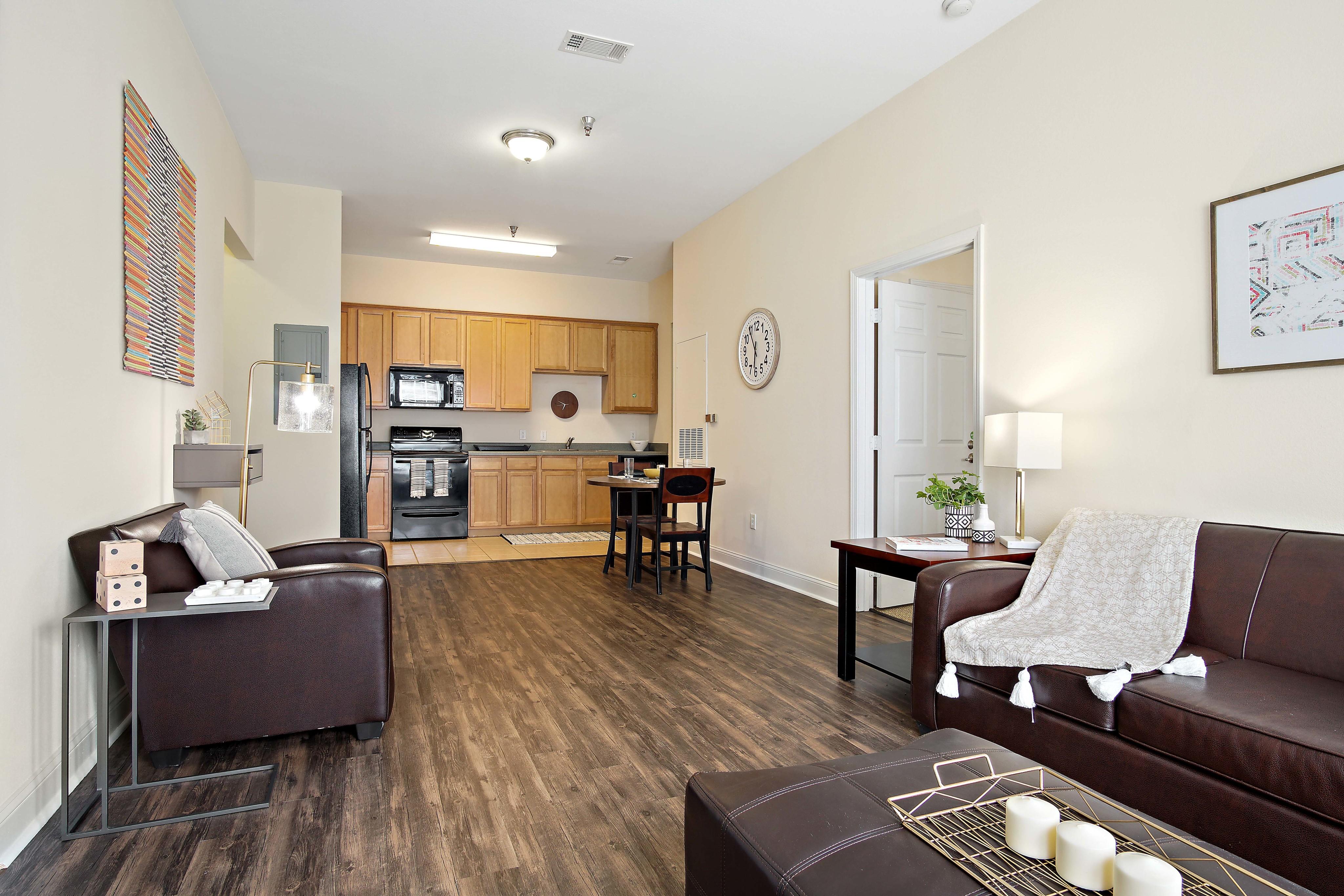 Open concept living with kitchen, dining area, and living room. Central House on Stadium Apartments Mobile (251)272-4710