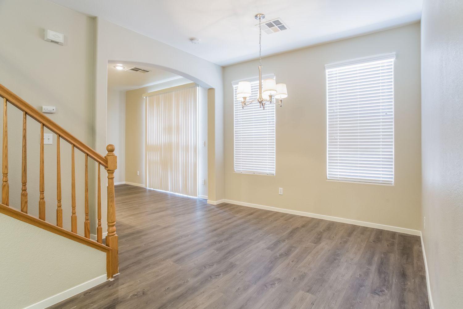 Invitation Homes Las Vegas living room with luxury vinyl plank flooring, large windows and plenty of natural light.