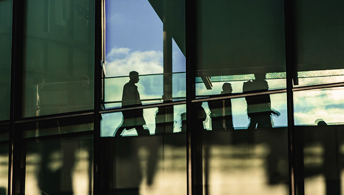 Businesspeople walking in an office building.