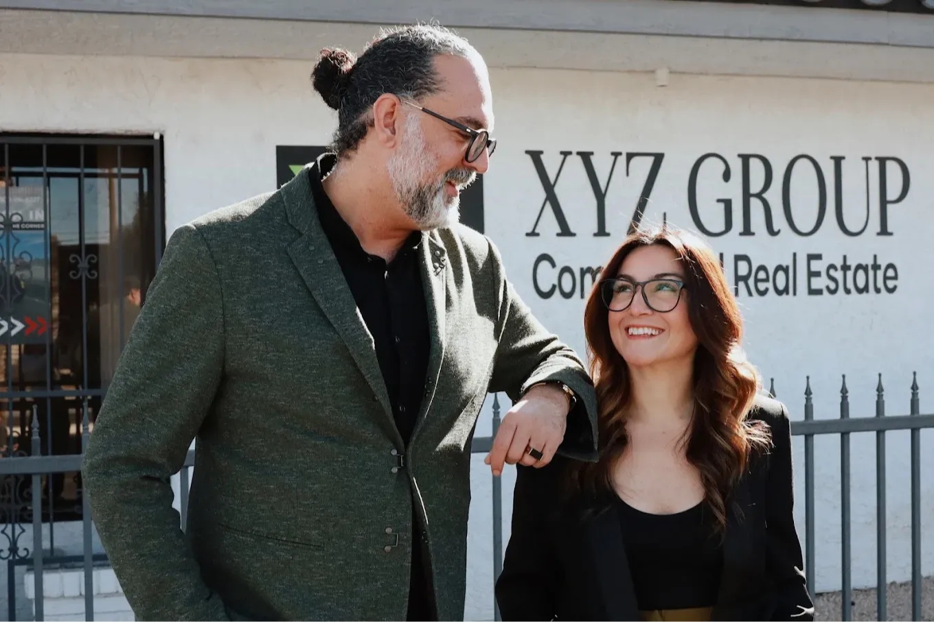 Maral Javanmard & Mo Kazemi the broker owners of XYZ Group Real Estate Las Vegas standing out front of the XYZ Group Headquaters on las Vegas Blvd