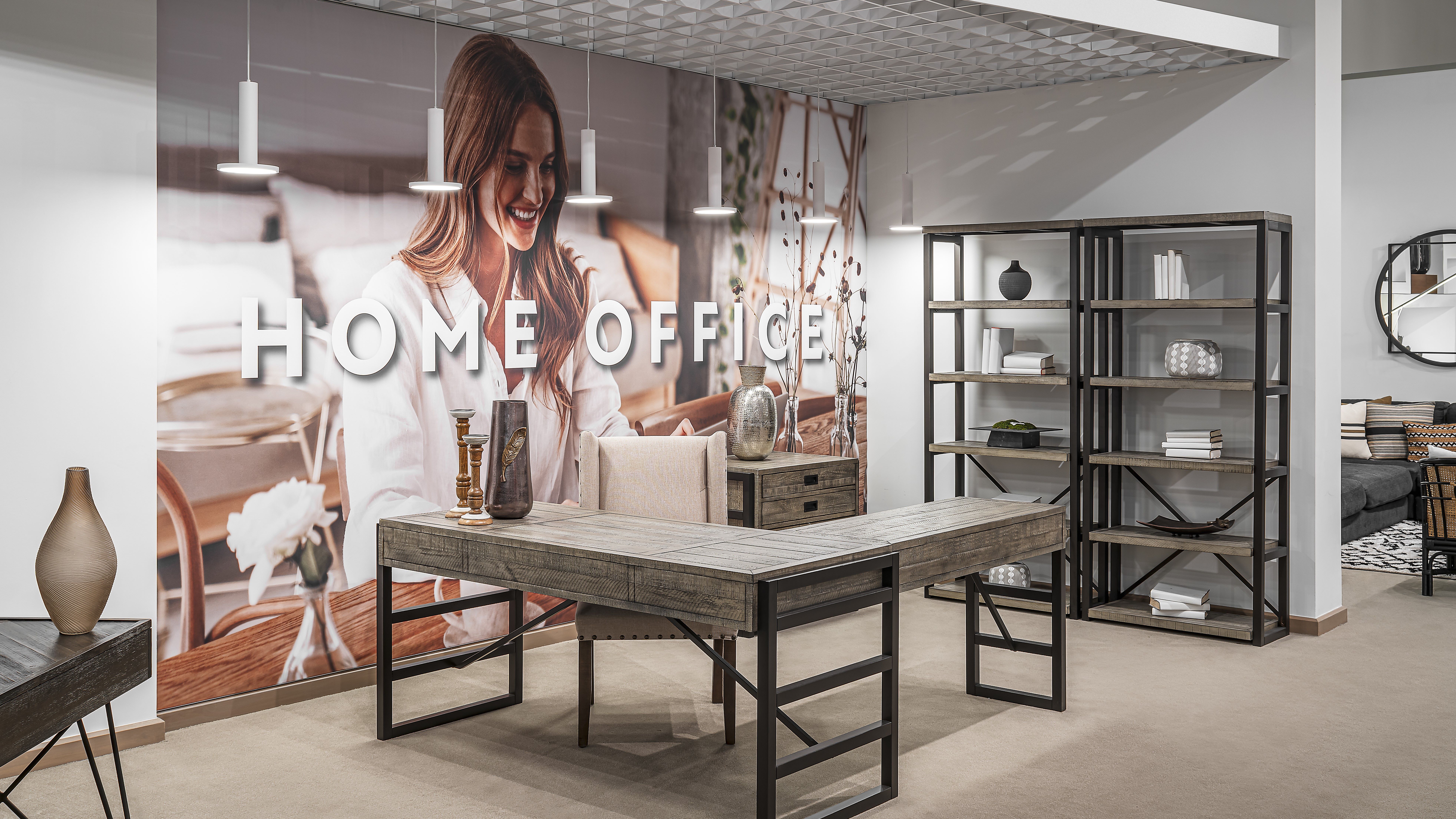 Modern home office setup with industrial-style furniture in a showroom.