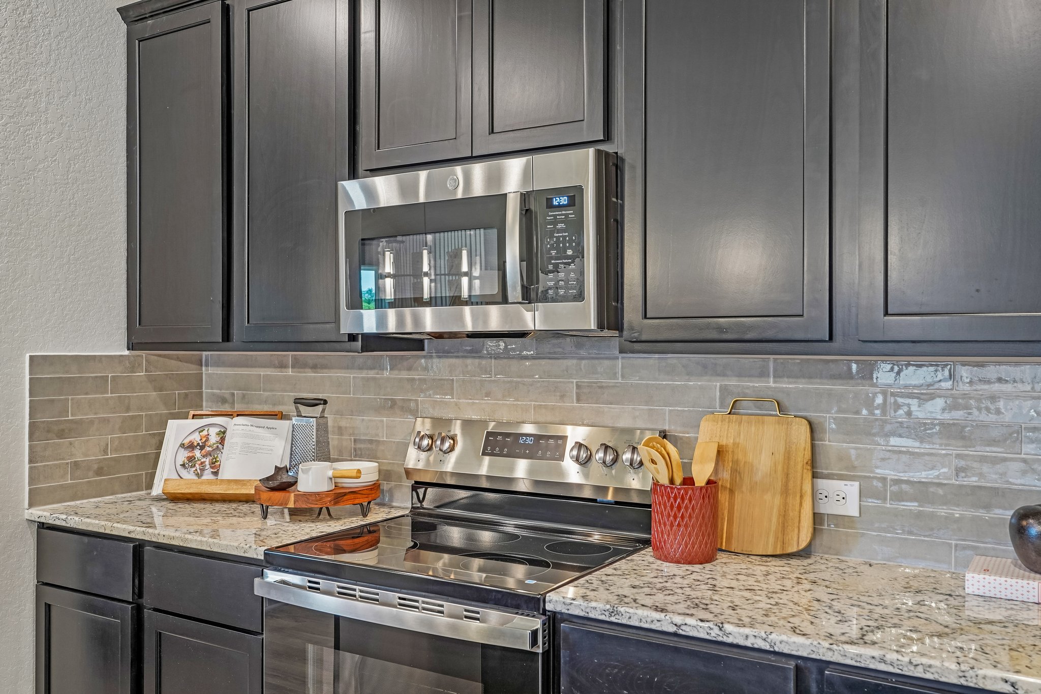 Modern Kitchen in New Braunfels with Dark Cabinets, Center Island & Designer Pendant Lighting at Clo 