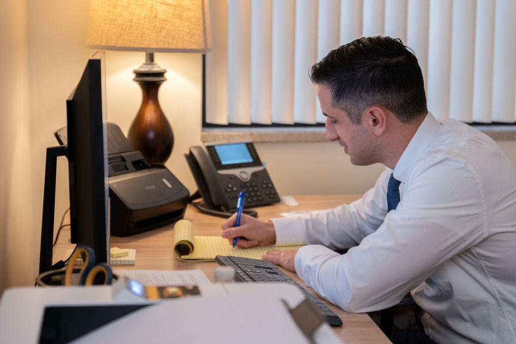 Michael Selario writing notes about a personal injury case he's working on