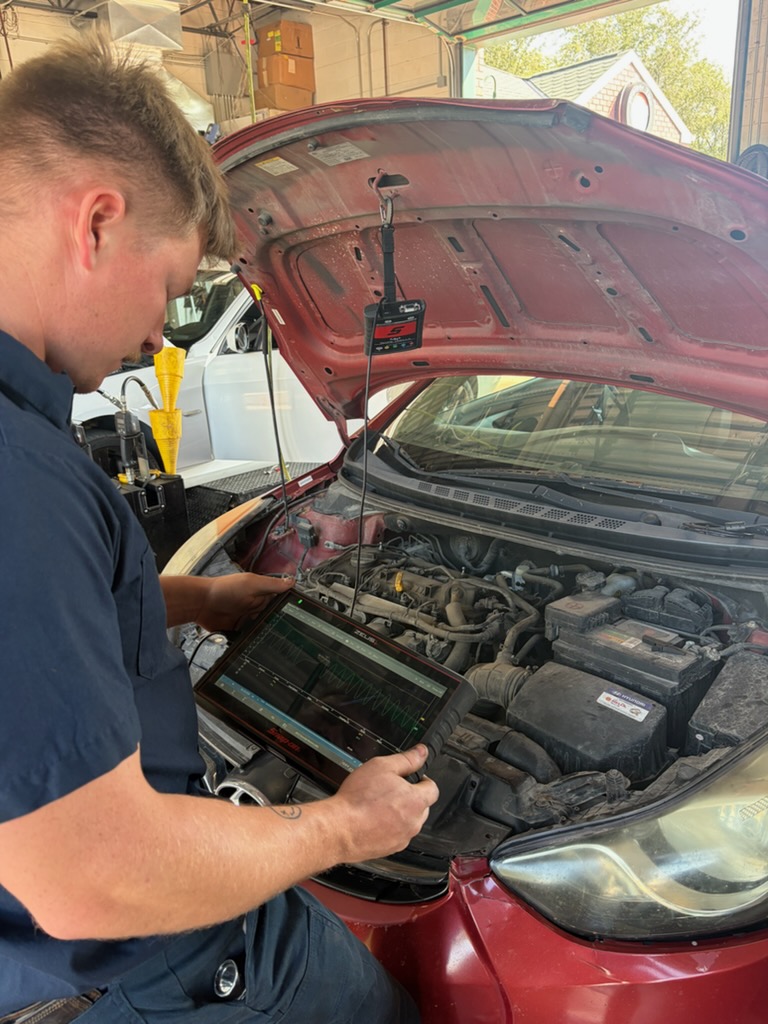 Walker Tire Point S technician performing automotive service at our 48th & Pioneer location in Lincoln.