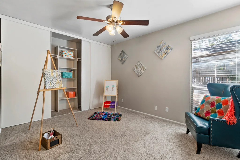 Bedroom with ceiling fan and open closet shelving