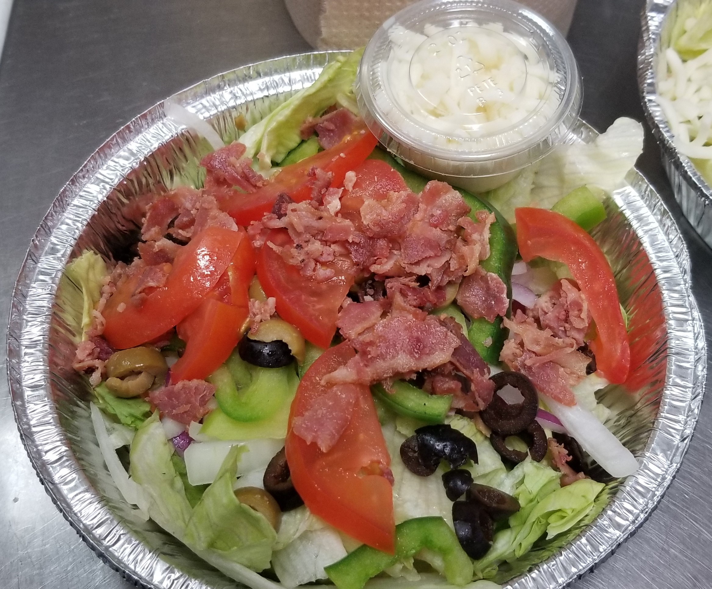 House dinner salad loaded with veggies and cheese on the side!