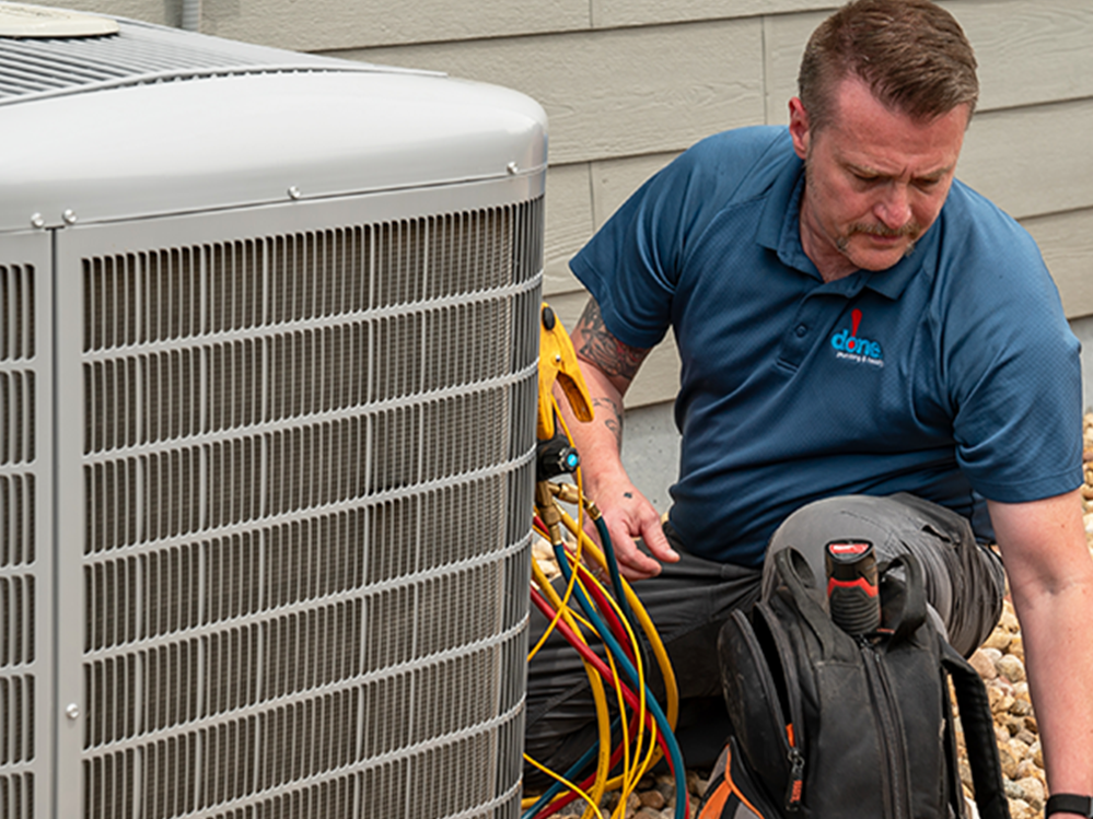 A Done HVAC technician repairing an AC system in the fall