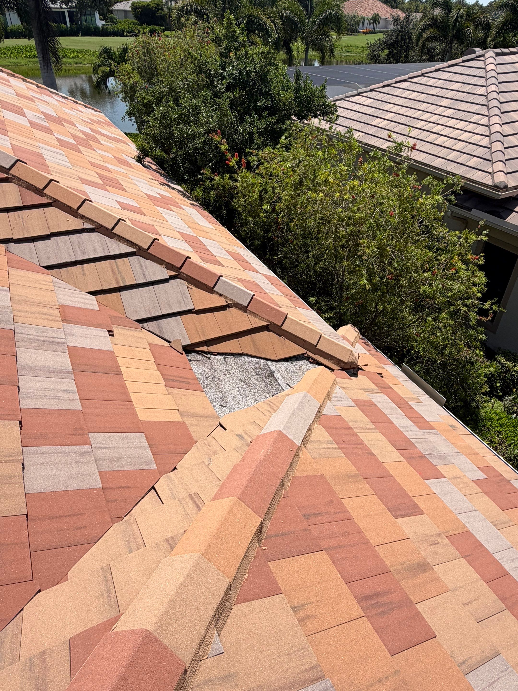Completed tile roof on a luxury residential home with a clean driveway, landscaped front yard, and t 