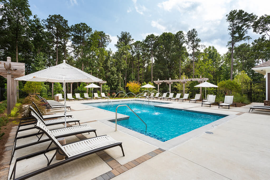 Gorgeous Modern Pool with Sunshelf and Lounge Chairs for Relaxing at Echo at North Pointe Center Apartment Homes