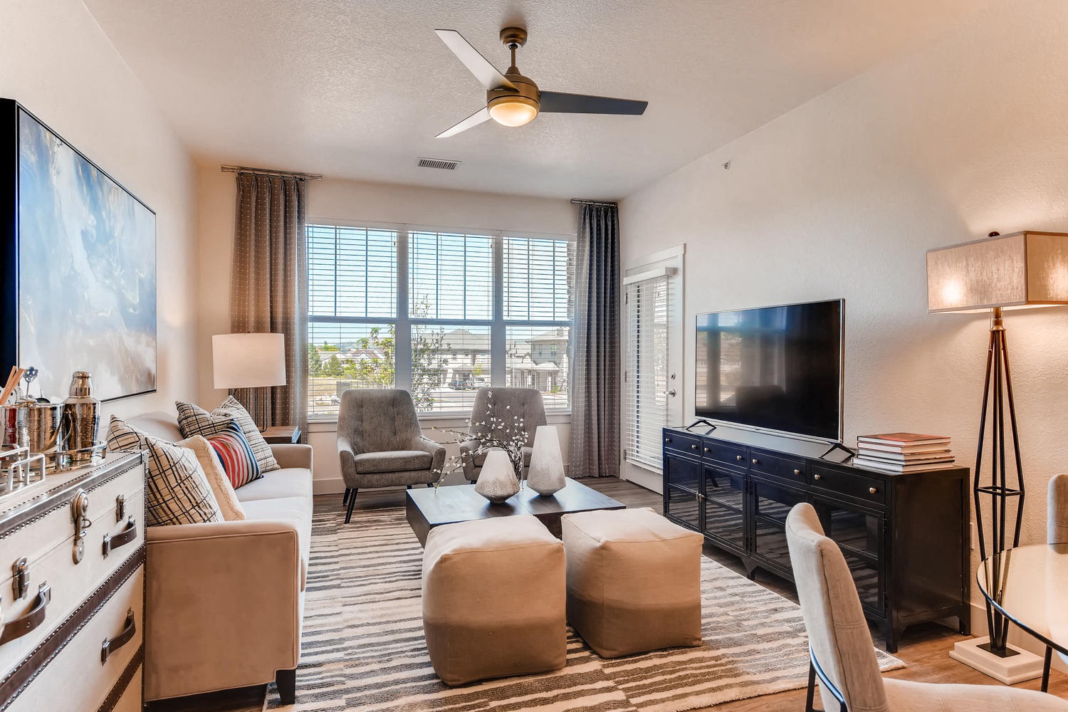 A living room with a television, a couch, and a chair.