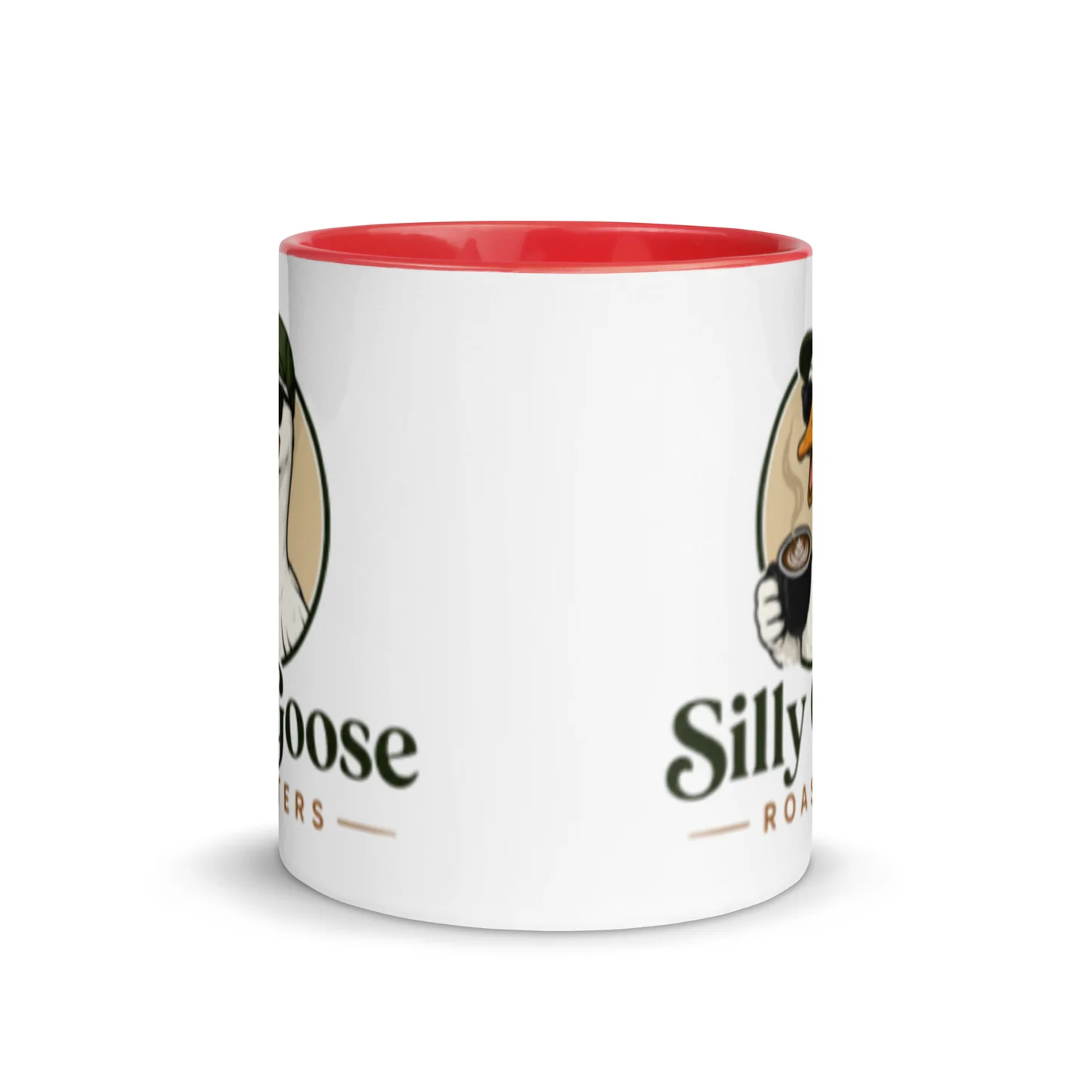 A white mug with a red interior is shown. The mug features a cartoon illustration of a goose wearing a green hat and holding a cup of coffee. The text 'Silly Goose Roasters' is printed on the mug.