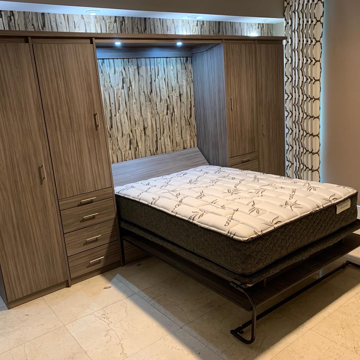 Custom Murphy bed open in wood wall unit with built in lighting