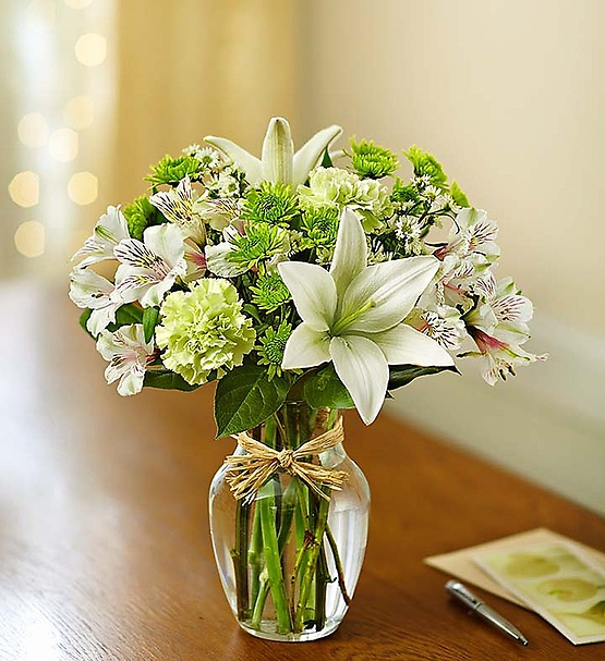 Bring peace and serenity to someone special in your life. Inspired by the quiet beauty of nature, our soothing arrangement is hand-designed with the freshest blooms in delicate shades of green and white and arranged in a classic gathering vase tied with raffia. Just one look will have them smiling and reflecting on your thoughtfulness!