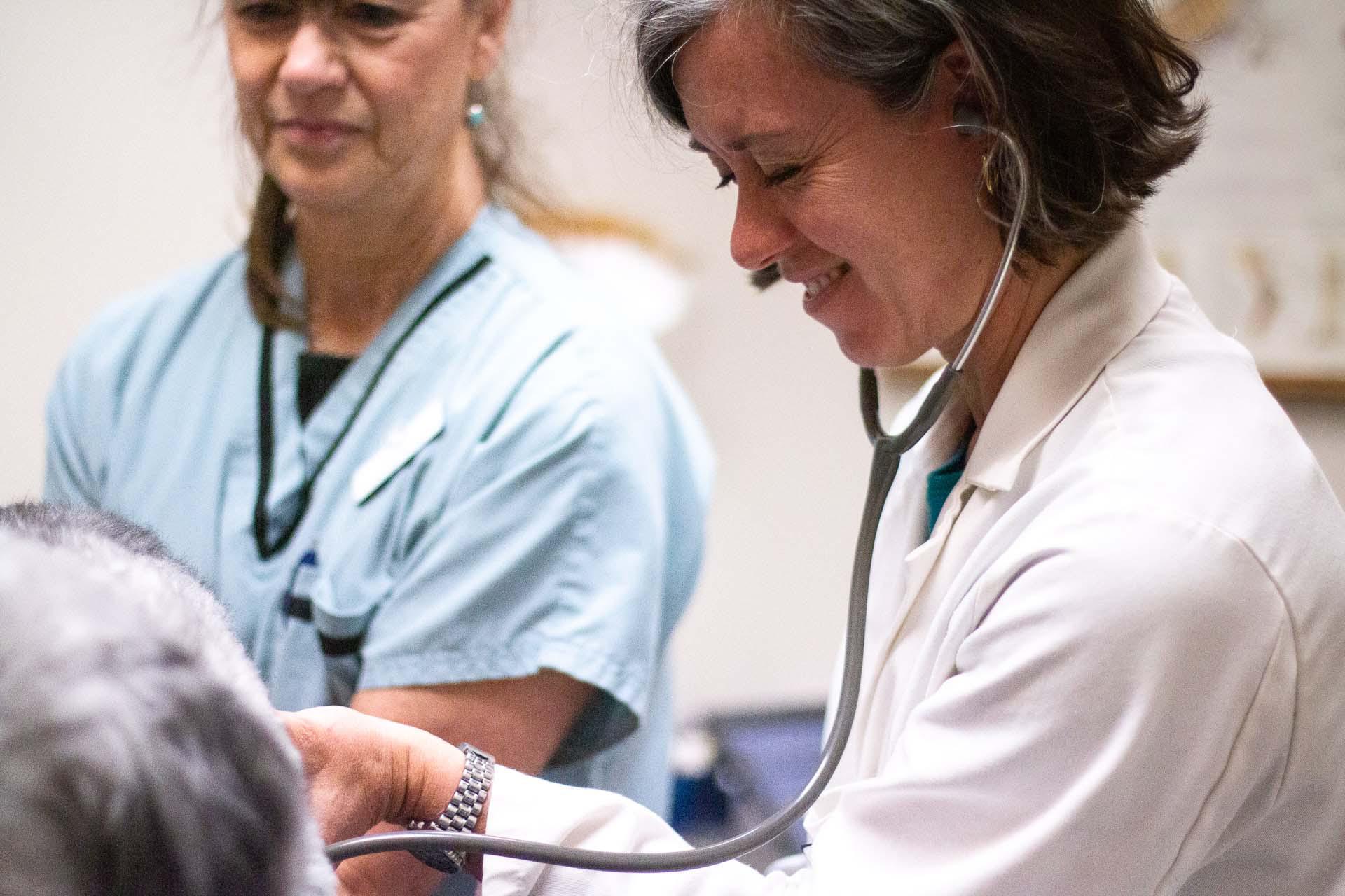 Dr. Bryant uses a stethoscope to listen to a patient’s heart and lungs.