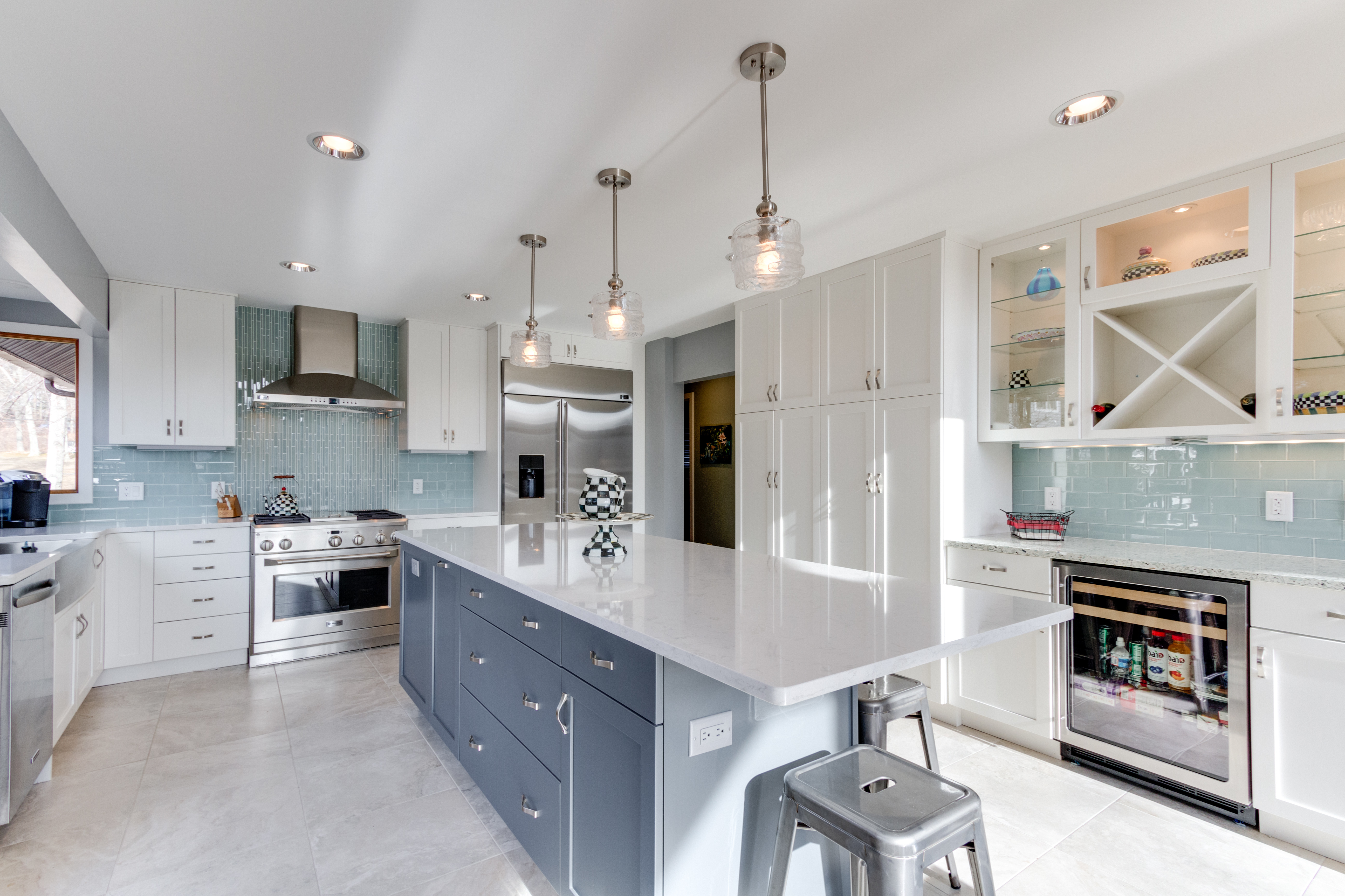 Two finish kitchen cabinets in white and blue-gray finishes.