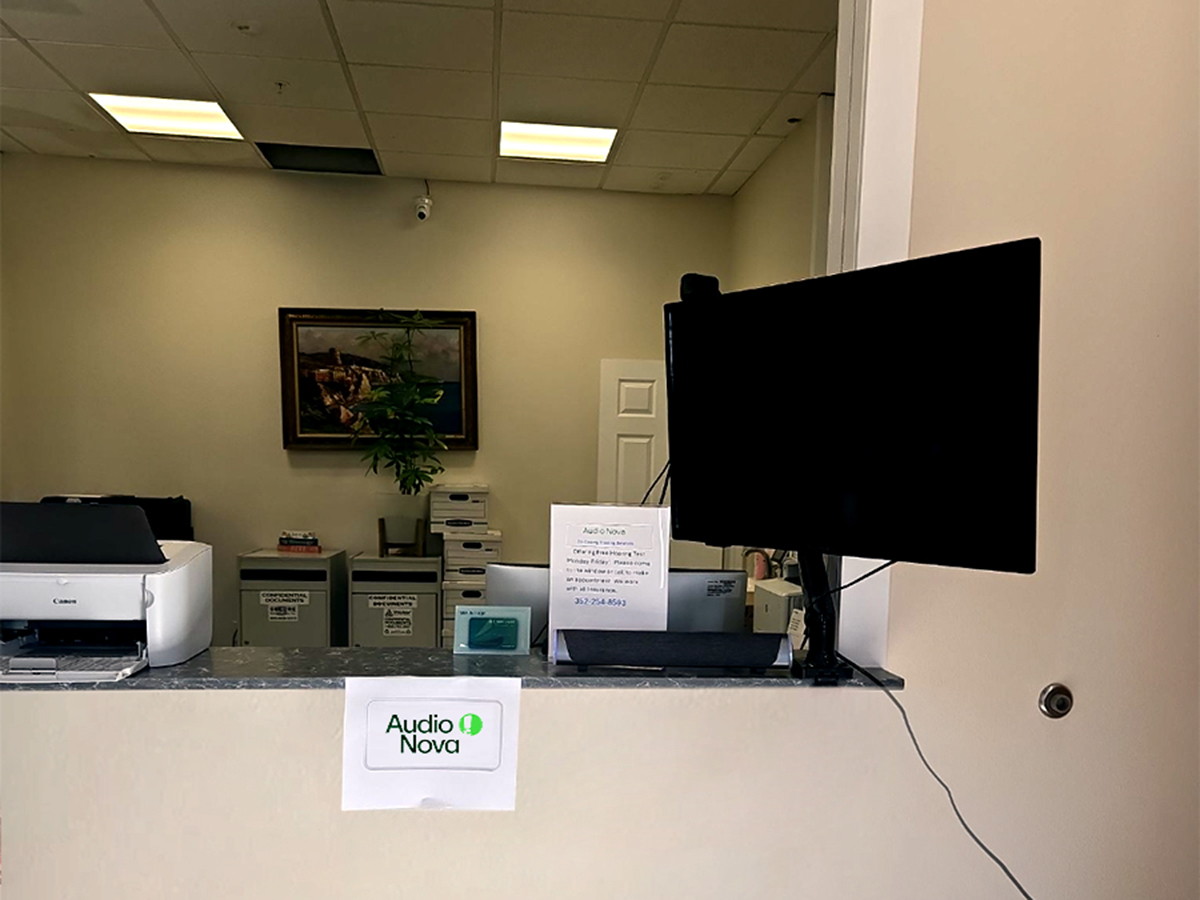 Interior photo of the front desk for AudioNova hearing clinic in Bushnell, FL