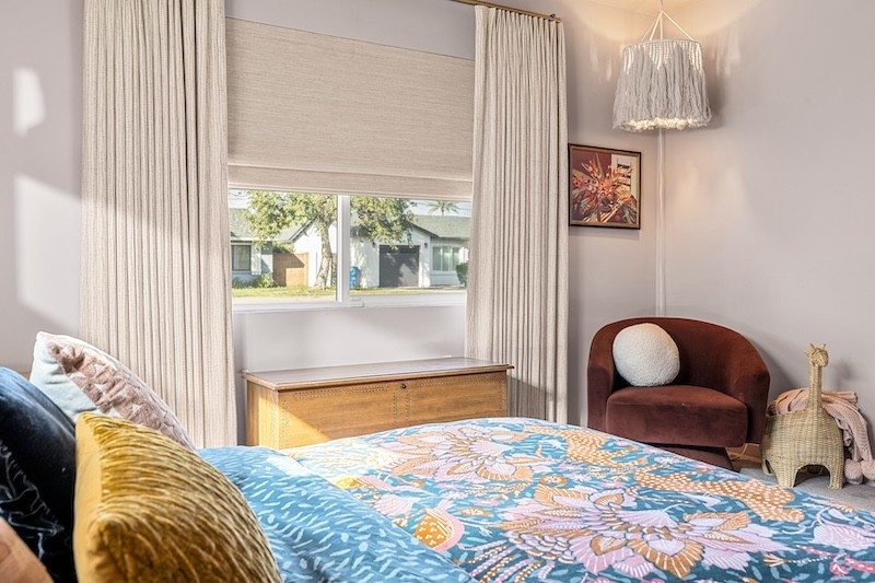 Layering window treatments is one of the easiest ways to add warmth and depth to a space! Check out how this contemporary bedroom paired these natural woven wood shades with these elegant drapes to create an inviting feel to this space. Plus, this combination provides you with ample light control!