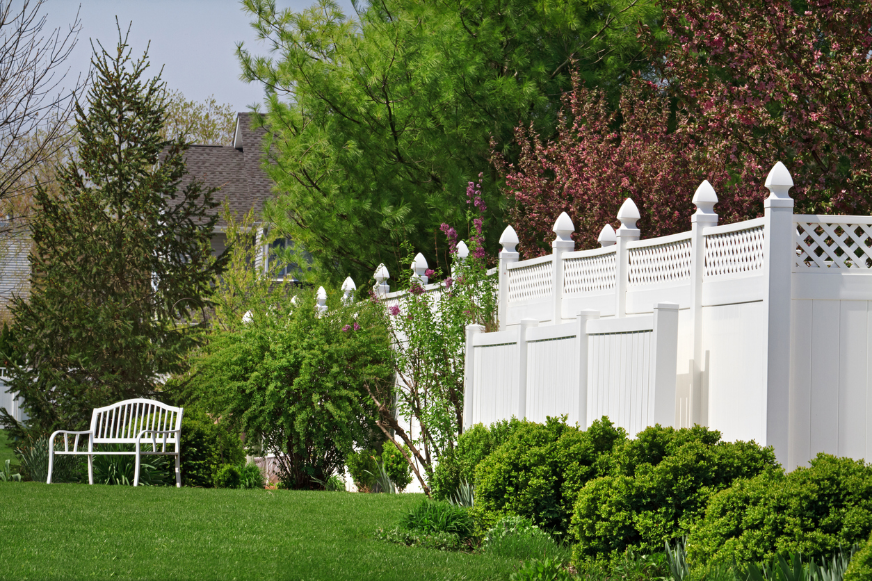 White vinyl fencing with decorative fence post tops and lattice