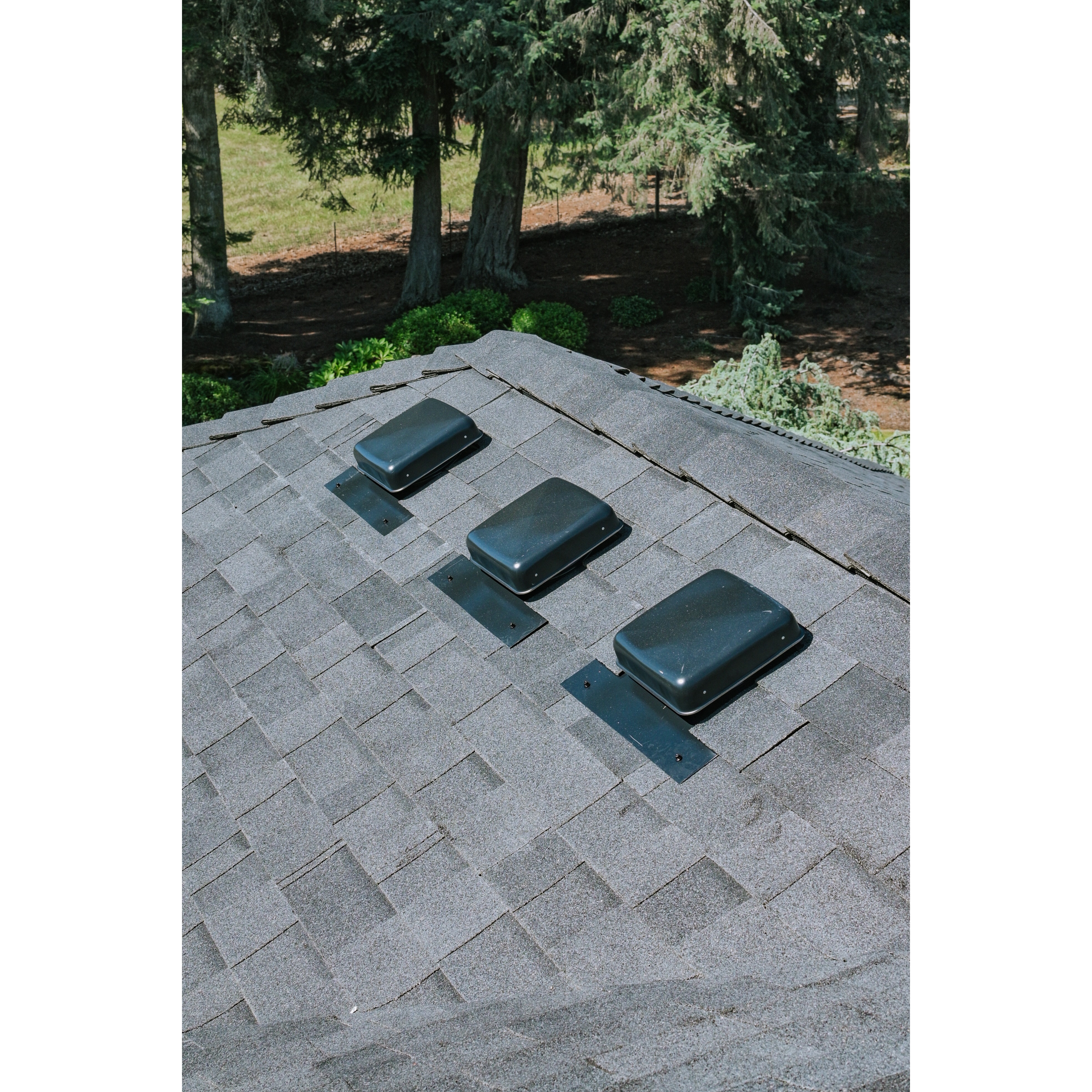 Residential asphalt shingle roof with multiple roof vents installed for attic ventilation. 