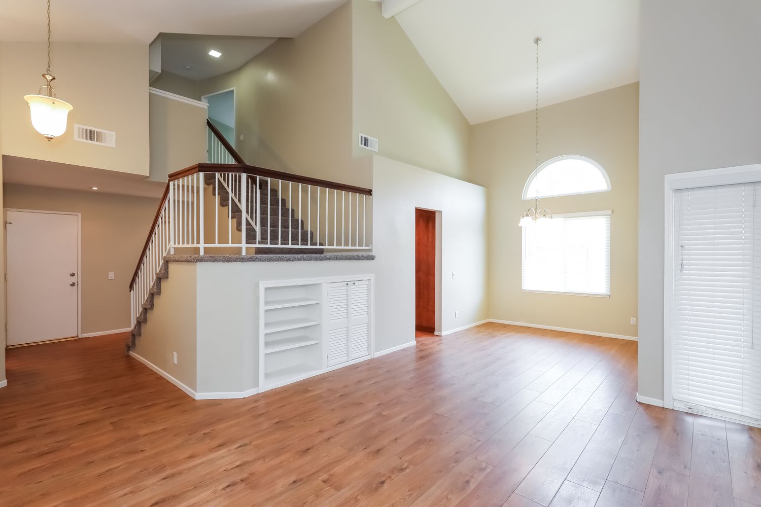 Entryway with updated floors and storage under the staircase at Invitation Homes Riverside.