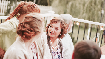 A mutigenerational family chatting during a party.