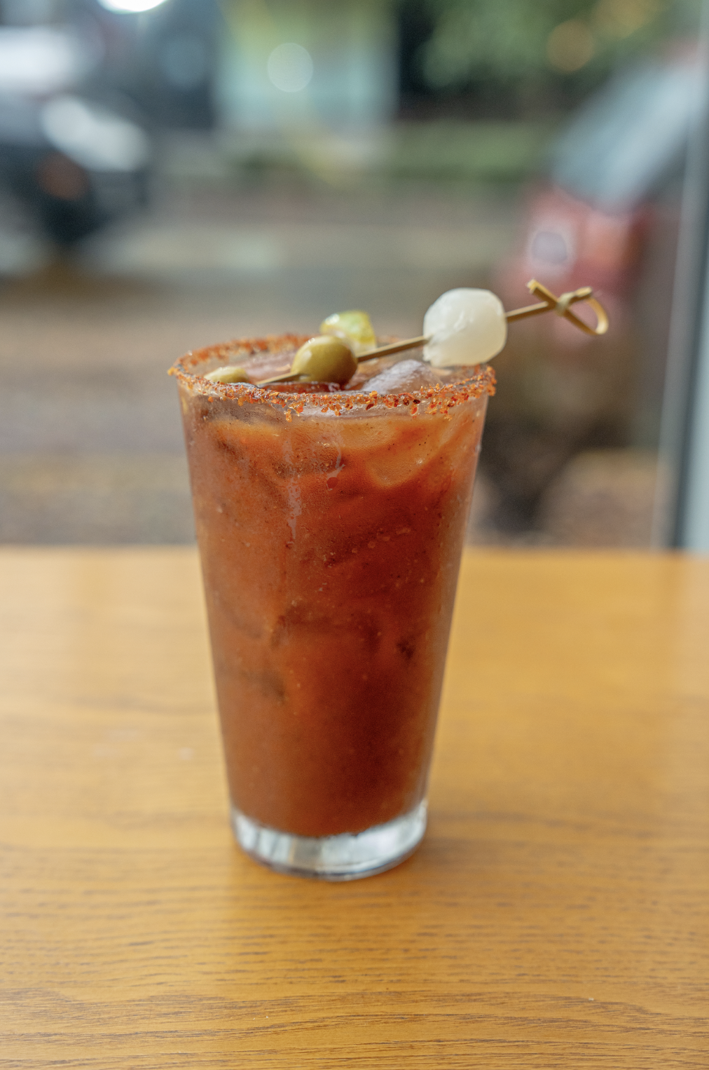 A large glass of a Bloody Mary drink