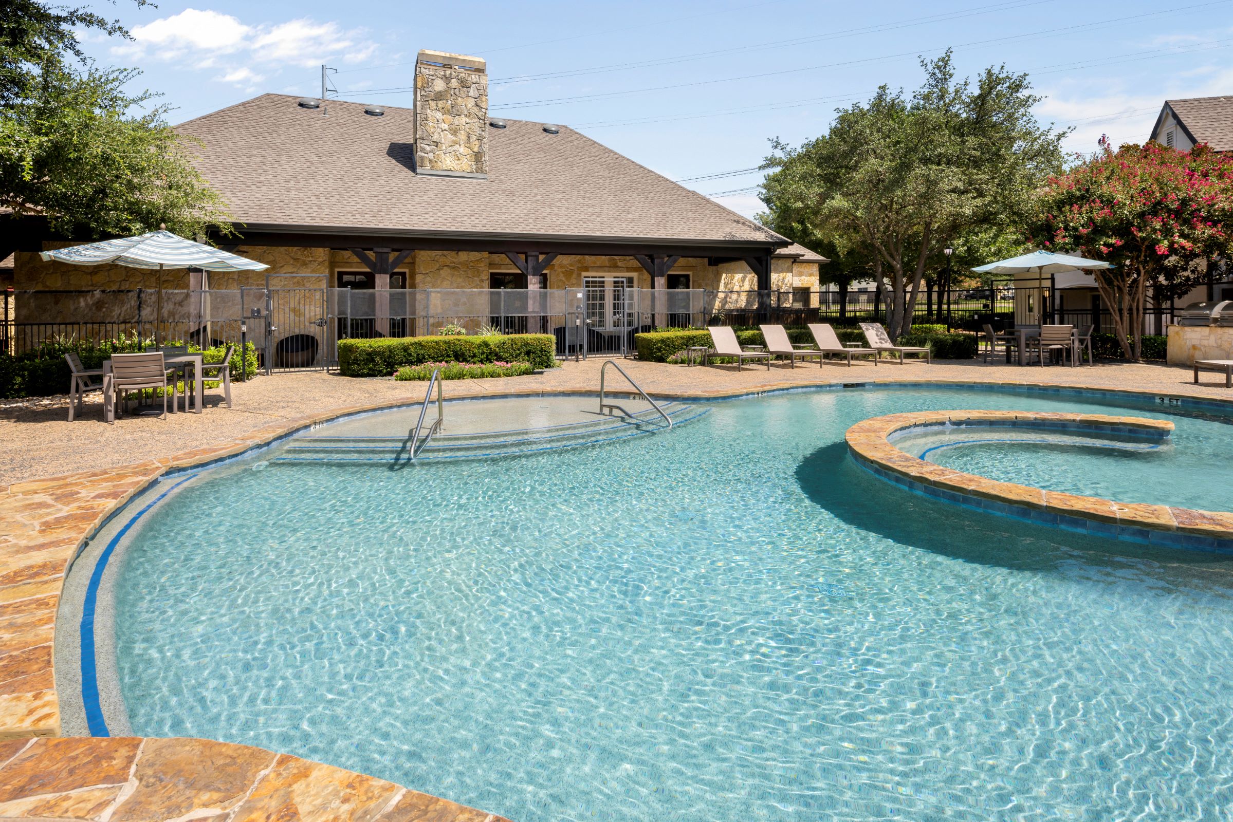 Top level of resort-style pool behind clubhouse at Camden Shadow Brook apartments in Austin, TX 
