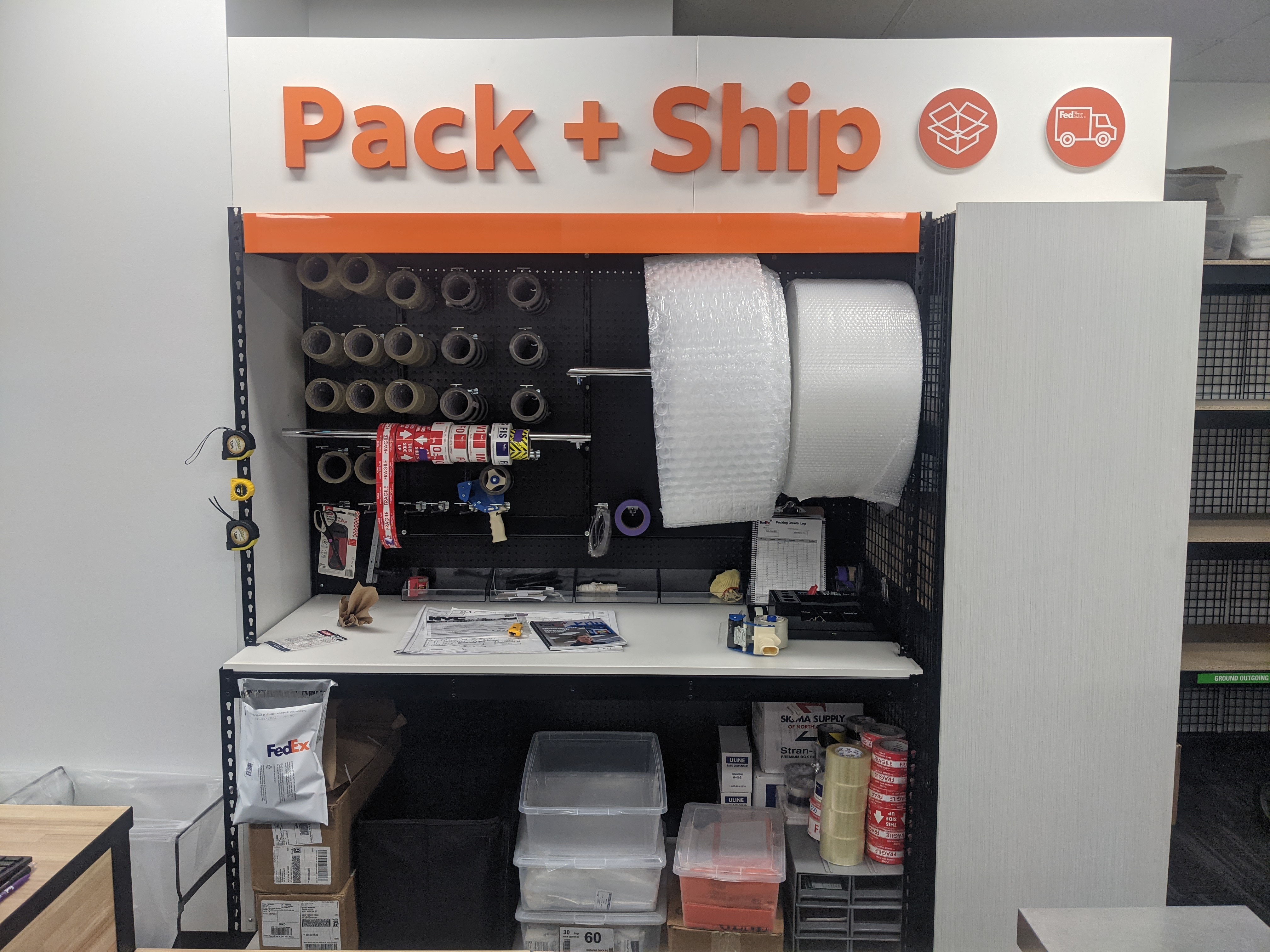 Pack and Ship Materials Station &ndash; Pack and ship area with bubble wrap, tape, and shipping supplies for secure packaging at FedEx Office East Village.
