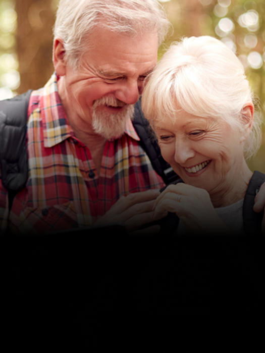 An elderly couple smiling together.