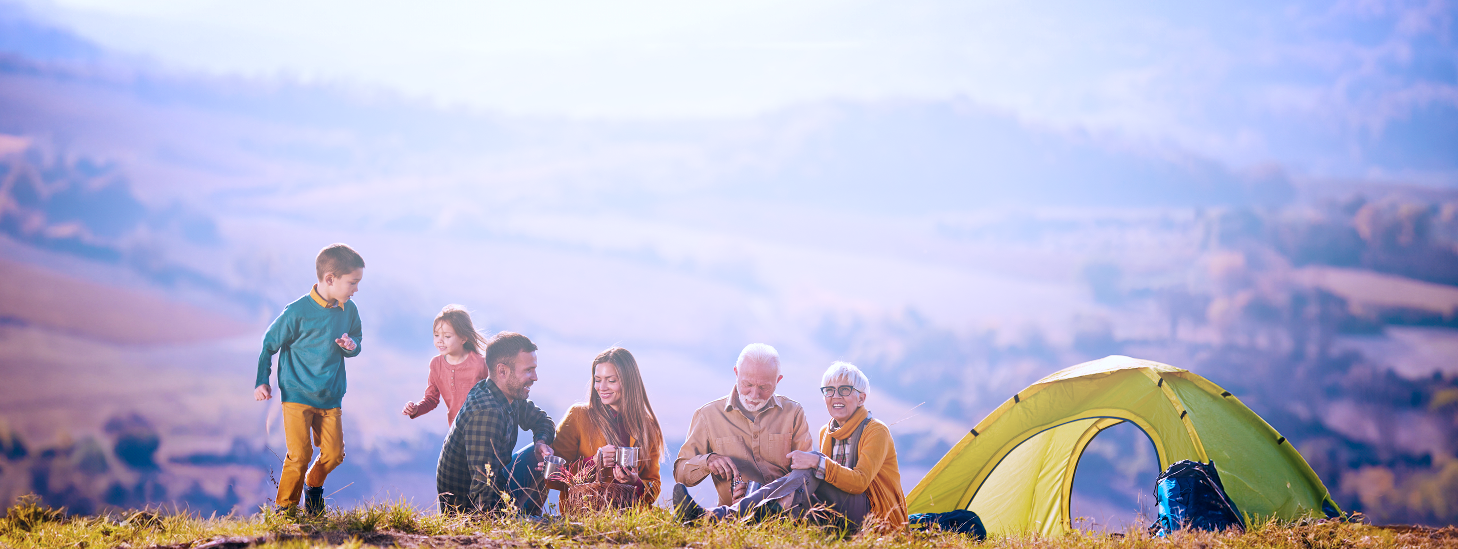 A multigenerational family camping in the mountains.