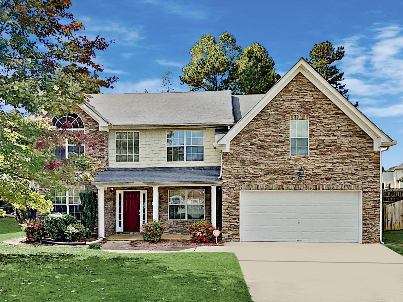 Gorgeous home with covered porch and a two-car garage at Invitation Homes Atlanta.