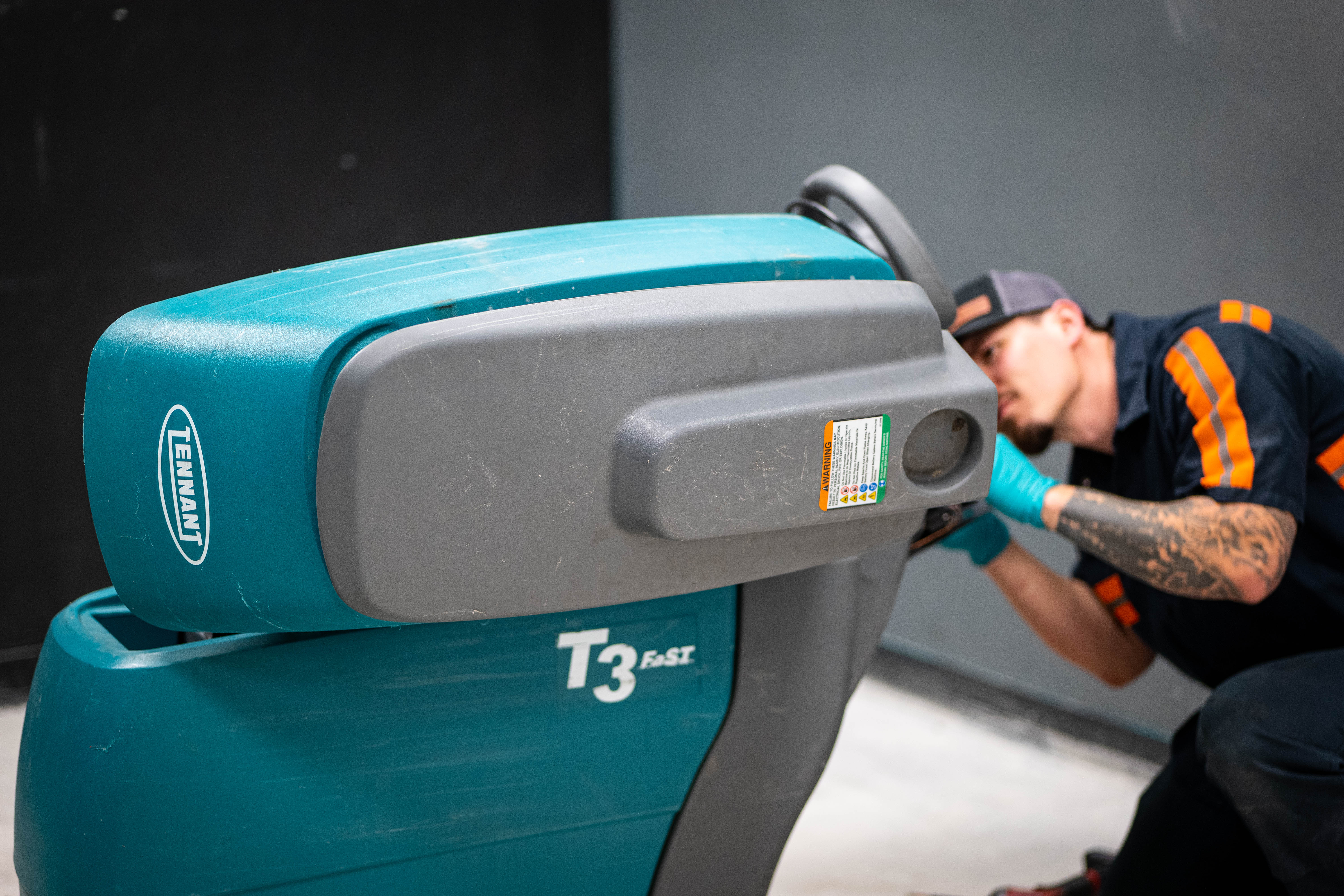 Equipment Model: Tennant T3 FAST Walk-Behind Scrubber
Action: Steering column and upper control console maintenance
Personnel: WaySolutions technician in a branded high-visibility uniform
Service Focus: Commercial walk-behind scrubber diagnostics and repair