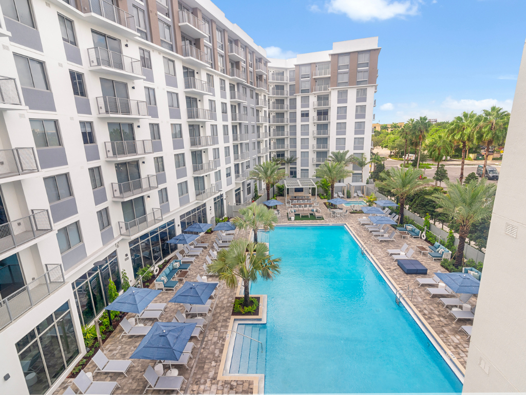 Pool Deck with Heated Pool, Lap Lane, Sun Loungers, and More at The Marc Luxury Apartments in Palm Beach Gardens FL