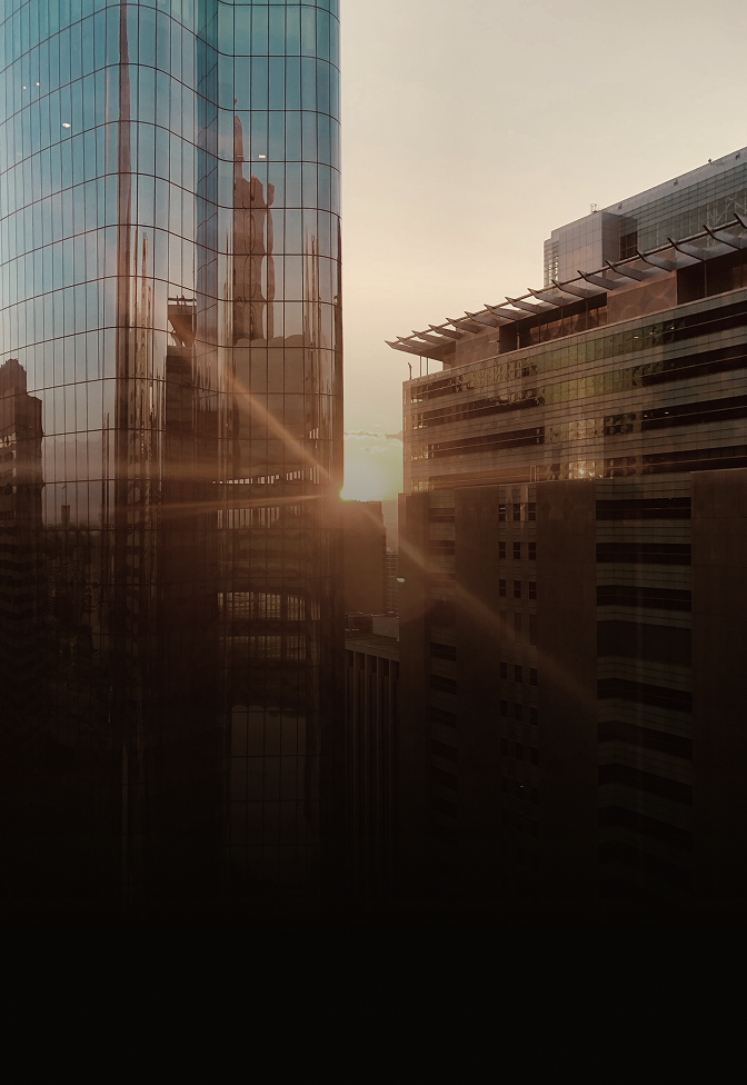 Shot of office buildings with warm light reflecting.