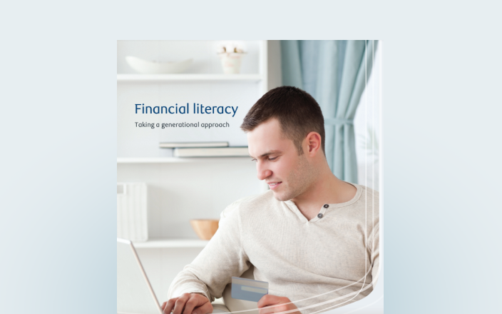 Cover of the financial literacy guide with a young man on his laptop.