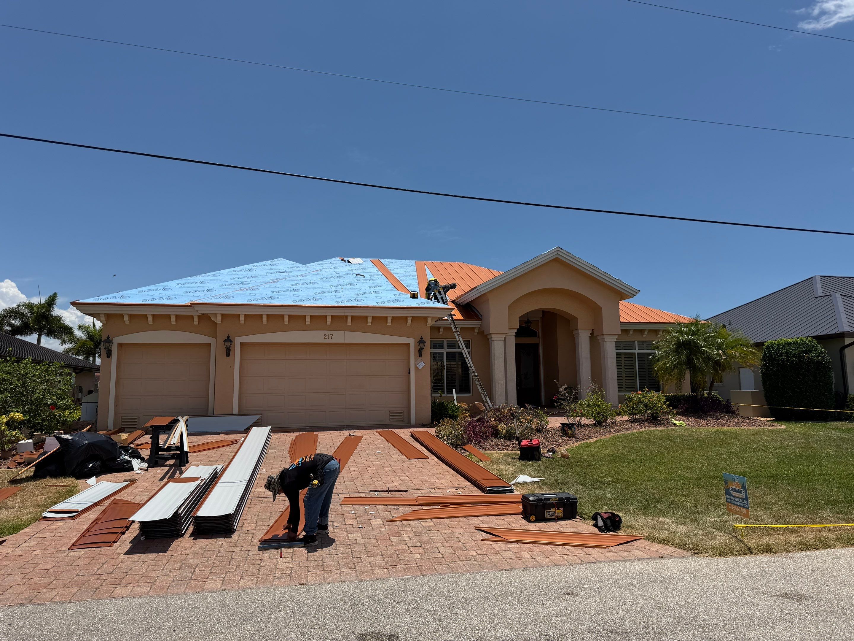 Newly installed copper standing seam metal roof on a waterfront home, showing clean panel alignment  