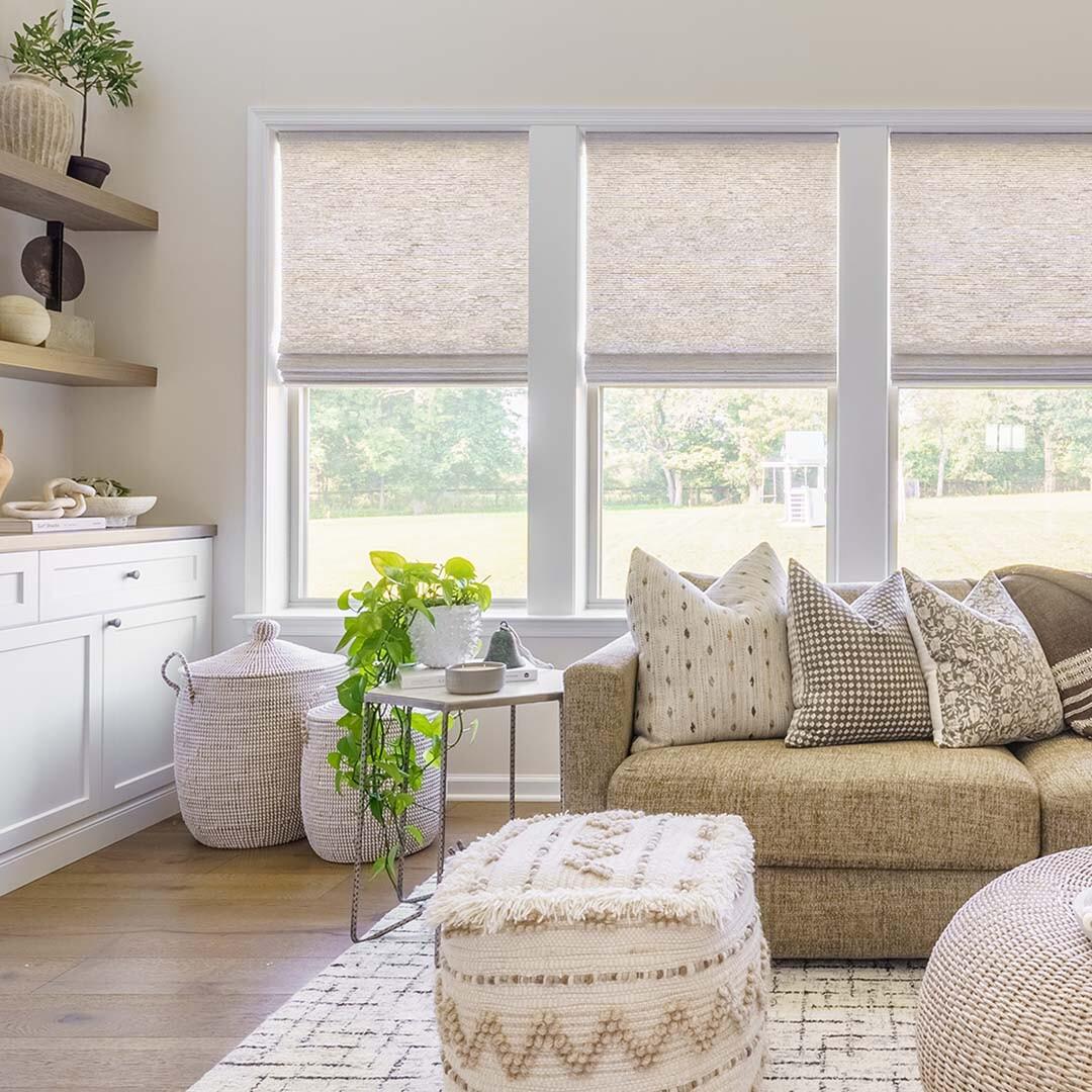 Bright, vibrant spaces like this cozy living room shown here benefit from warm natural light pouring in. We love how these woven wood shades complement the smooth earth tones and allow plenty of light to enter the space.