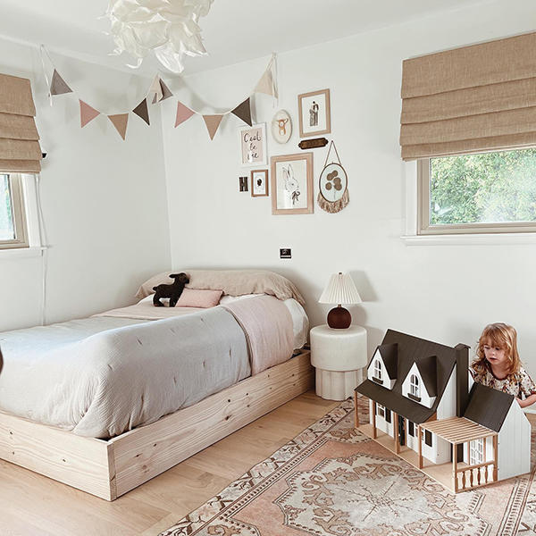 Add color and privacy to your child's room with highly-versatile Roman shades. These shades expertly accentuate the wood grain elements in this bedroom.