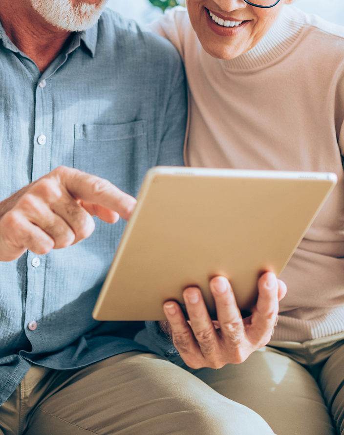 Two people examining a tablet.