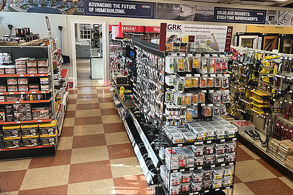 Well-stocked interior aisles at Builders FirstSource New Bedford featuring nails, screws, adhesives, and other construction supplies.