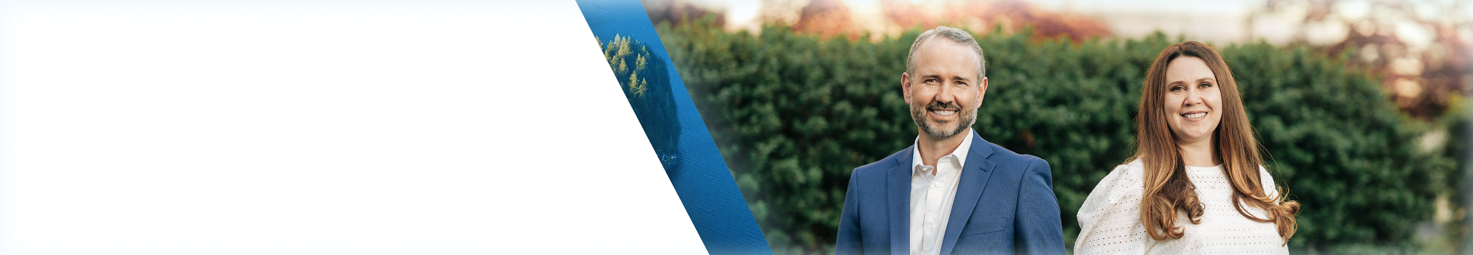 Jordan Anderson and Anastasiia Razmiasova standing together in front of a hedge.