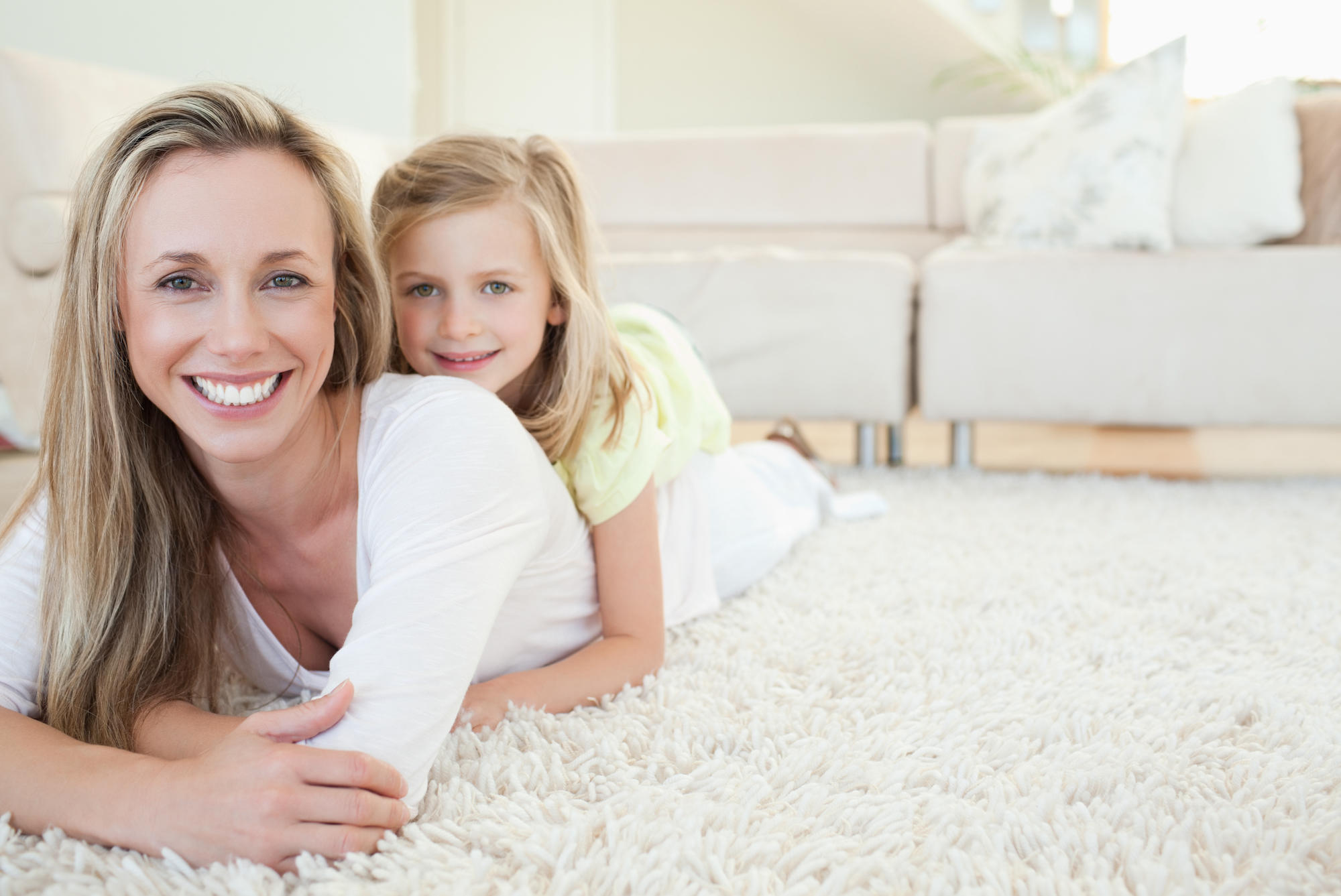 Mother and daughter on clean carpet