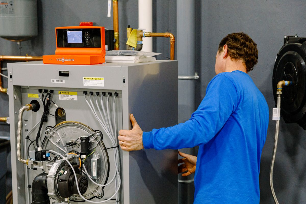 A Beaupre Fuels technician servicing a residential heating system in Southern Maine. Beaupre Fuels provides expert HVAC services, furnace repair, boiler installation, heating maintenance, and energy-efficient heating solutions for homes and businesses.