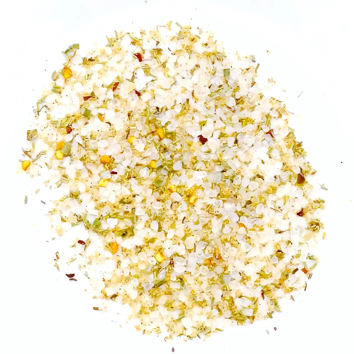 A pile of coarse sea salt mixed with dried herbs and chili flakes, presented against a stark white background.